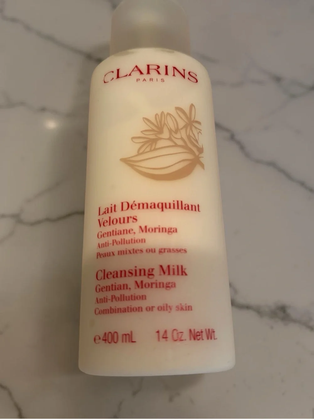 Clarins Cleansing Milk with Red Logo on Cream Bottle